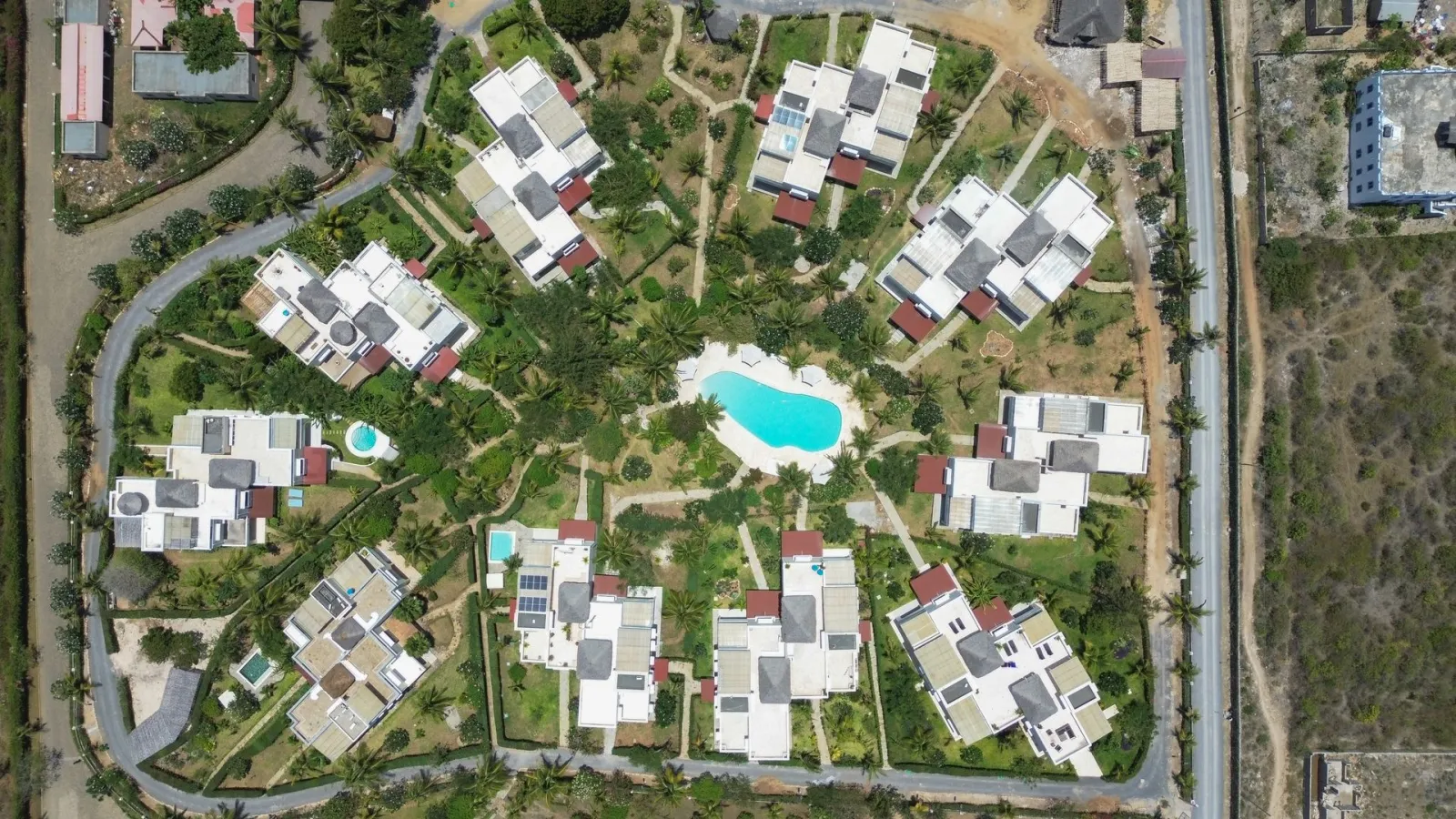 Paparemo Village and its gardens from the air, the ocean beyond