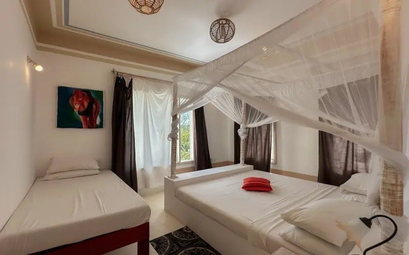 A double bedroom with mosquito nets
