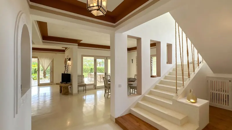 The staircase rising from the living room
